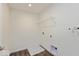 A utility room featuring a white wire shelf, a floor basin, and utility hook ups at 1105 Gatewick Ct, Greenwood, IN 46143