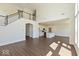 Open-concept living space featuring a staircase, hardwood floors, and a combined kitchen with white cabinetry at 1105 Gatewick Ct, Greenwood, IN 46143