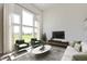 Spacious living room featuring high ceilings, large windows, stylish furniture, and a sleek entertainment center at 1105 Gatewick Ct, Greenwood, IN 46143