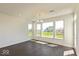 Sunlit living room with hardwood floors and large windows overlooking the backyard at 1105 Gatewick Ct, Greenwood, IN 46143