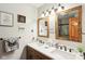 Bathroom with a dual vanity featuring a wooden cabinet and wooden framed mirrors at 5707 Kensington Blvd, Plainfield, IN 46168