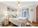 Cozy bedroom with hardwood floors, a comfortable bed, and natural light from the window at 5707 Kensington Blvd, Plainfield, IN 46168