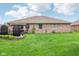 Expansive backyard featuring lush lawn, brick home and lovely landscaping at 5707 Kensington Blvd, Plainfield, IN 46168
