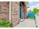 Charming front porch with a blue door, brick archway, and cozy seating at 5707 Kensington Blvd, Plainfield, IN 46168