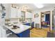 Bright kitchen with a breakfast bar and a view into the dining room area at 5707 Kensington Blvd, Plainfield, IN 46168