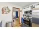 Modern kitchen with stainless steel appliances, access to the dining room, and white cabinetry at 5707 Kensington Blvd, Plainfield, IN 46168