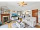 Comfortable living room with wood burning fireplace adjacent to the bright kitchen area at 5707 Kensington Blvd, Plainfield, IN 46168