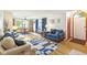 Open-concept living room with hardwood floors, blue accents, and seamless flow to the dining area at 5707 Kensington Blvd, Plainfield, IN 46168