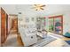 Spacious living room with hardwood floors, comfortable seating, and access to the backyard at 5707 Kensington Blvd, Plainfield, IN 46168