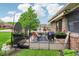Inviting backyard patio with stylish furniture, string lights, and a garden, perfect for outdoor living at 5707 Kensington Blvd, Plainfield, IN 46168