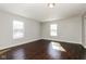 Bedroom featuring two windows that provide natural light and hardwood flooring at 5060 Staughton Dr, Indianapolis, IN 46226