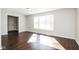 Bright living room with hardwood floors and a large window, offering plenty of natural light at 5060 Staughton Dr, Indianapolis, IN 46226
