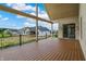 Covered back porch with railing, offers a scenic view of the backyard and surrounding neighborhood at 5469 Harness Dr, Greenwood, IN 46143