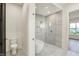 Bright bathroom featuring a toilet, modern marble flooring, and a glass door for the stand-up shower at 5469 Harness Dr, Greenwood, IN 46143