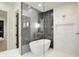 Modern bathroom boasts marble floors, a luxurious soaking tub, and a glass-enclosed shower at 5469 Harness Dr, Greenwood, IN 46143