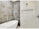 This bathroom features a soaking tub, a shower, and a built-in shelf for added convenience at 5469 Harness Dr, Greenwood, IN 46143