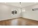 Bright bedroom with wood floors, fan, and large windows offering natural light and neighborhood views at 5469 Harness Dr, Greenwood, IN 46143