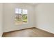 Bedroom featuring hardwood floors and a window overlooking a neighborhood at 5469 Harness Dr, Greenwood, IN 46143