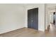 Bedroom featuring hardwood floors, a double door closet and a glimpse of the hallway at 5469 Harness Dr, Greenwood, IN 46143