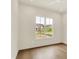 Bright bedroom features hardwood floors and a window offering neighborhood views at 5469 Harness Dr, Greenwood, IN 46143