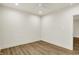 Open bedroom featuring wood-look flooring and neutral walls with recessed lighting at 5469 Harness Dr, Greenwood, IN 46143