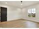 Well-lit bedroom features hardwood floors and a large window with a pleasant neighborhood view at 5469 Harness Dr, Greenwood, IN 46143