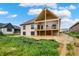 Home's exterior showcasing a covered porch that enhances the property's appeal, perfect for outdoor living at 5469 Harness Dr, Greenwood, IN 46143