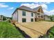Back of the home features a covered porch, dark trim windows and white painted brick at 5469 Harness Dr, Greenwood, IN 46143