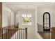 Second floor hallway with hardwood floors, modern chandelier, and lots of natural light at 5469 Harness Dr, Greenwood, IN 46143