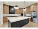 Modern kitchen featuring a large island, custom cabinets, and stainless steel appliances at 5469 Harness Dr, Greenwood, IN 46143