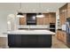 Modern kitchen featuring a large island, custom cabinets, and stainless steel appliances at 5469 Harness Dr, Greenwood, IN 46143