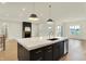 Kitchen island with marble countertops and adjacent living and dining areas at 5469 Harness Dr, Greenwood, IN 46143