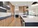 Modern kitchen features an island with seating, marble countertops, and stainless appliances at 5469 Harness Dr, Greenwood, IN 46143