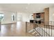 Open-concept living area with hardwood floors and an adjacent kitchen at 5469 Harness Dr, Greenwood, IN 46143