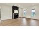Open living area featuring hardwood floors and a modern fireplace at 5469 Harness Dr, Greenwood, IN 46143