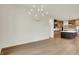 Living room view featuring a stylish chandelier and kitchen access at 5469 Harness Dr, Greenwood, IN 46143