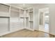 Large walk-in closet boasts custom shelves and drawers and an entrance to the bathroom at 5469 Harness Dr, Greenwood, IN 46143