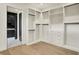 Bright walk-in closet with custom shelving and wooden floors, providing ample storage space at 5469 Harness Dr, Greenwood, IN 46143