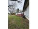 Backyard view showcasing the deck, detached garage, and outdoor space perfect for relaxation at 5625 Gateway Dr, Indianapolis, IN 46254