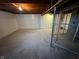 Unfinished basement area with sealed walls, concrete floor, and exposed pipes at 5625 Gateway Dr, Indianapolis, IN 46254