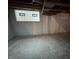 Finished basement area with sealed walls, concrete floor, and glass block window at 5625 Gateway Dr, Indianapolis, IN 46254
