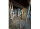 HVAC system and water heater in an unfinished basement with exposed beams and framing at 5625 Gateway Dr, Indianapolis, IN 46254