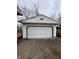 Detached garage with white siding and a black accent trim; ideal for secure parking and storage at 5625 Gateway Dr, Indianapolis, IN 46254