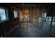 A partially renovated living room shows exposed beams and wood framing for dividing walls at 5625 Gateway Dr, Indianapolis, IN 46254