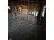 A partially renovated living room shows exposed beams and wood framing for dividing walls at 5625 Gateway Dr, Indianapolis, IN 46254