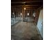 A partially renovated living room shows exposed beams and a doorway providing ample natural light at 5625 Gateway Dr, Indianapolis, IN 46254