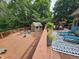 Large deck featuring outdoor seating and a shed, surrounded by lush trees, perfect for entertaining and relaxing at 620 Valley Dr, Martinsville, IN 46151