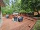 Large, tiered wooden deck with outdoor seating and lush greenery, perfect for entertaining and relaxation at 620 Valley Dr, Martinsville, IN 46151