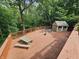 Expansive deck with ample seating and a storage shed overlooking a lush, green backyard at 620 Valley Dr, Martinsville, IN 46151