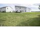 Large backyard with a well-maintained lawn, featuring a two-story home and neighboring houses at 975 Red Hills Ct, Lebanon, IN 46052